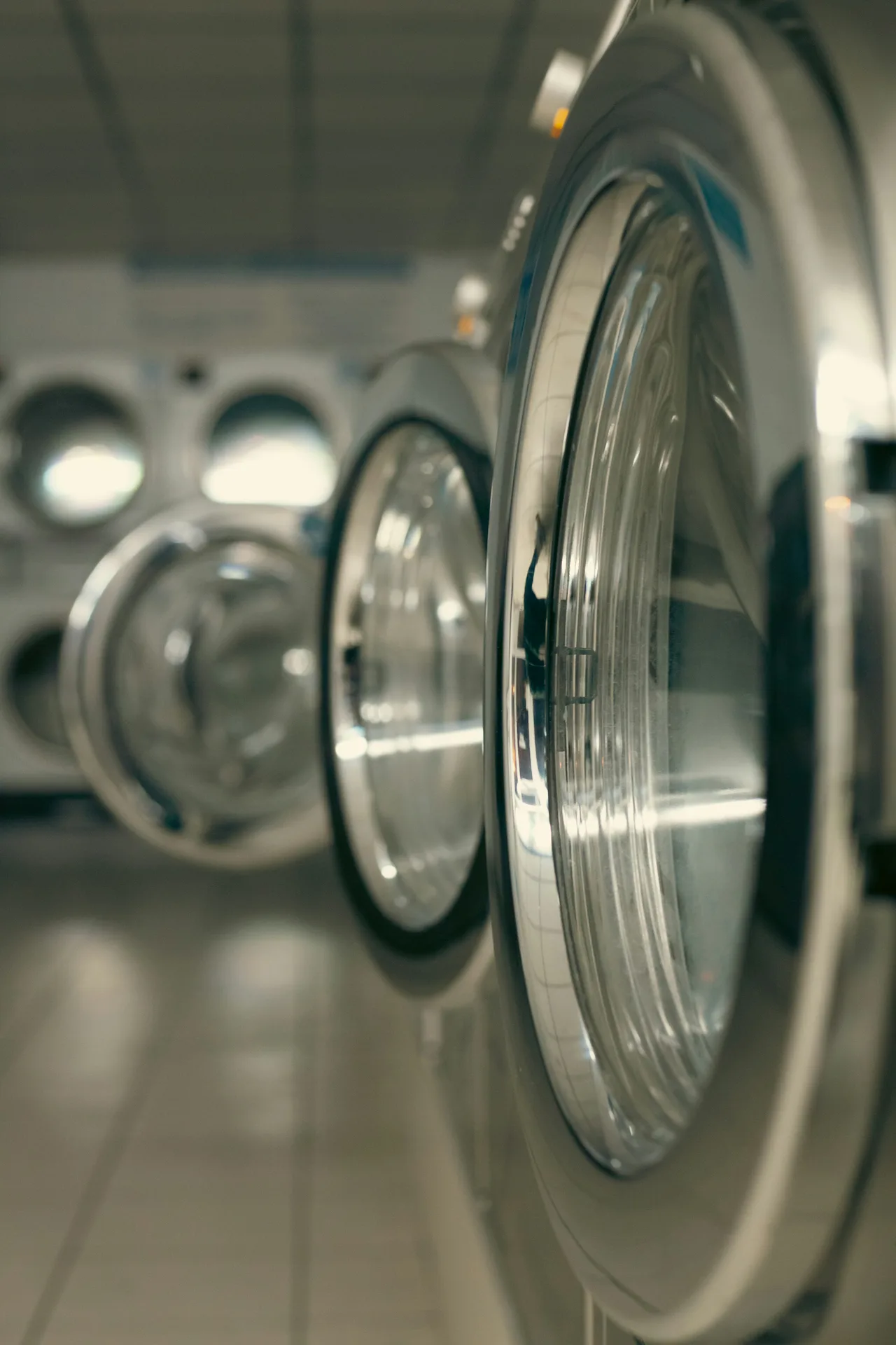 Row of commercial front-load machines — Appliance Repair Sherwood Park services on-premise commercial laundry equipment